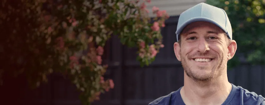 Man with narcolepsy type 1 smiling outdoors with a baseball glove on