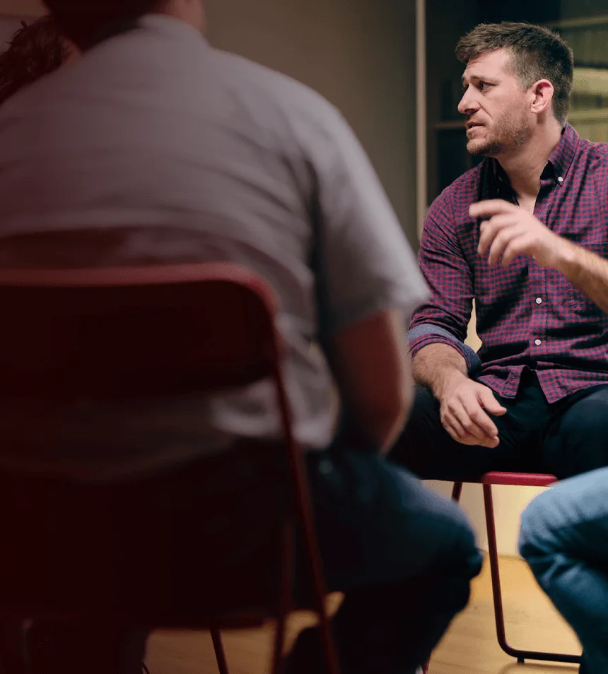 Man with narcolepsy type 1 sitting in a chair and talking in a support group