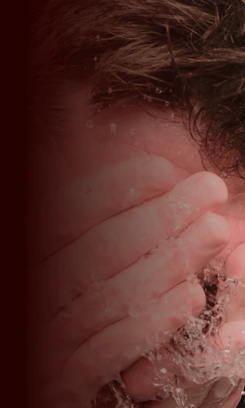 Man with narcolepsy type 1 splashing cold water on his face