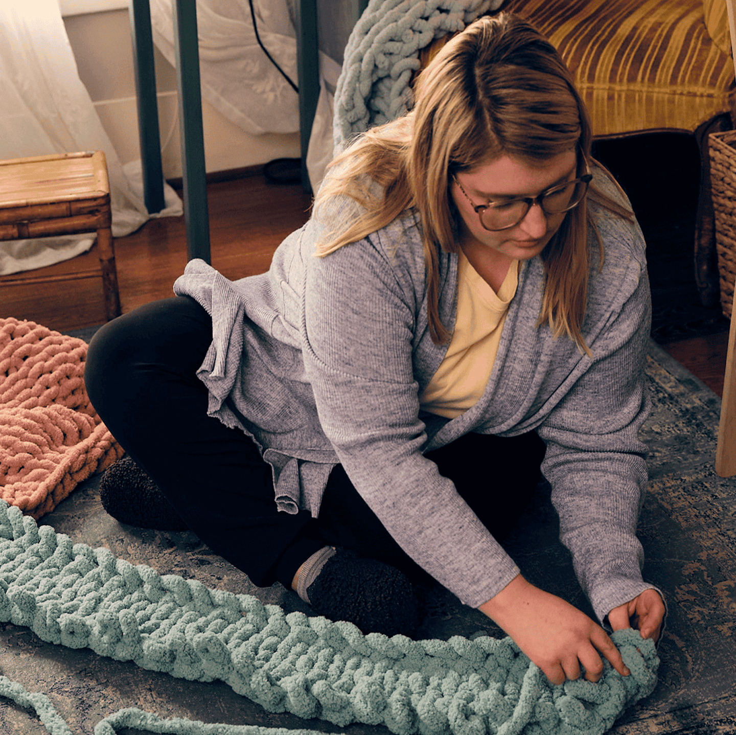 Woman with narcolepsy type 1 sitting on the floor and hand knitting