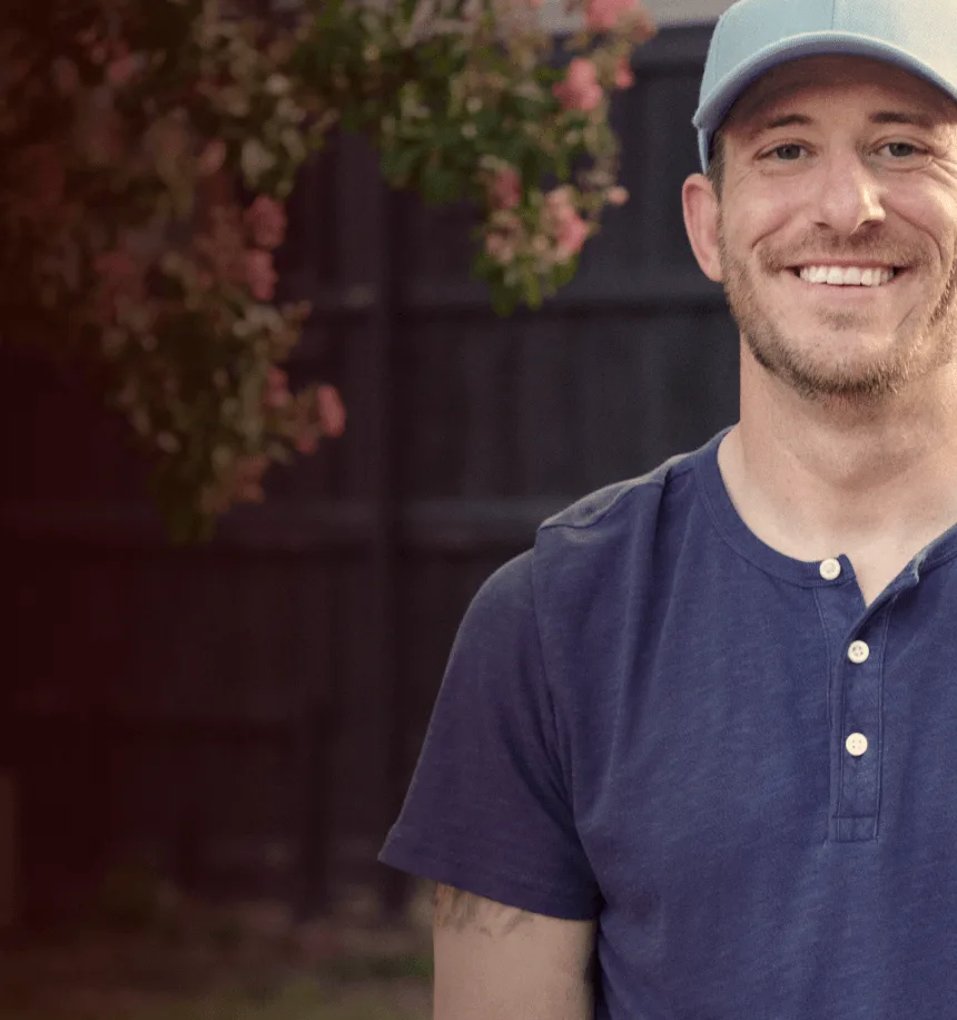 Man with narcolepsy type 1 smiling outdoors with a baseball glove on